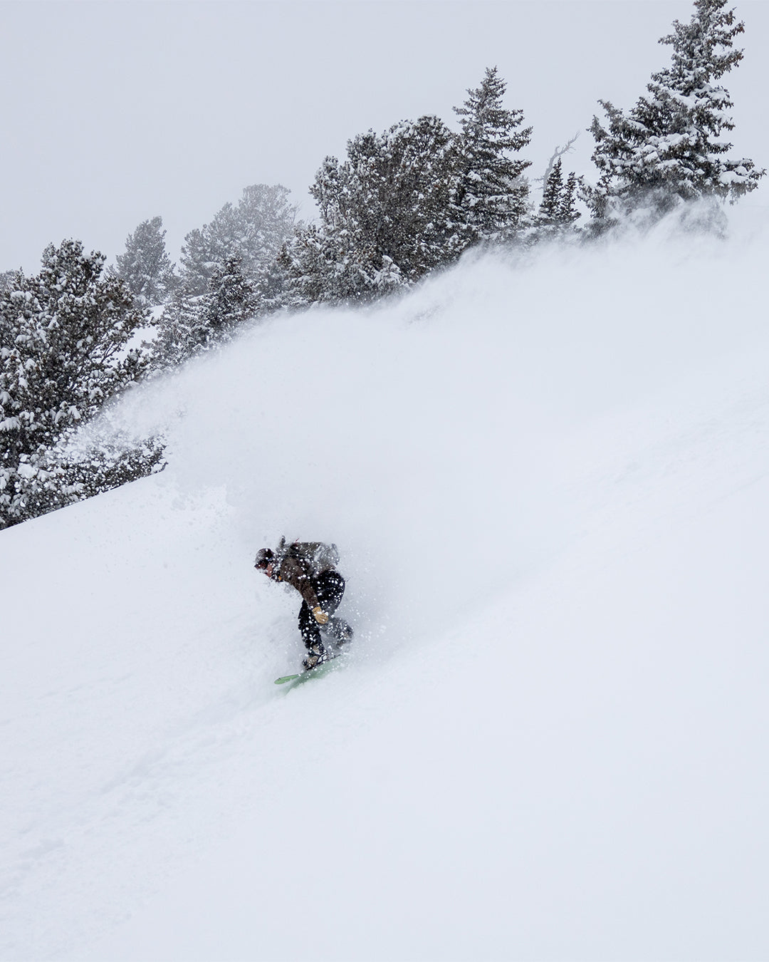 Griffin Siebert riding the Alternator snowboard down a snowy mountain
