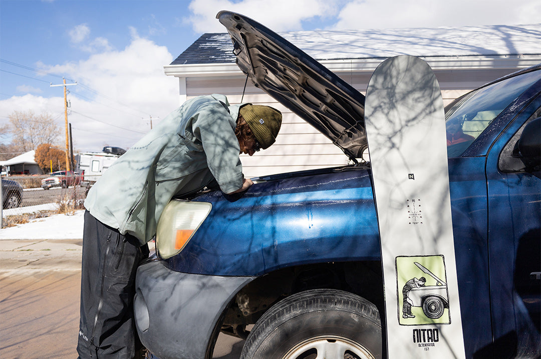 Griffin Siebert looking into a car's engine