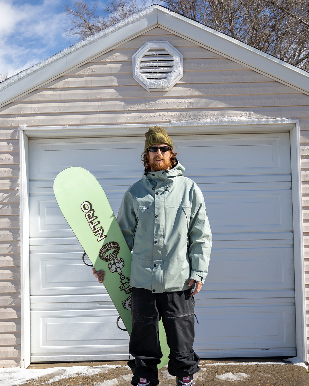 Griffin Siebert standing in front of a garage